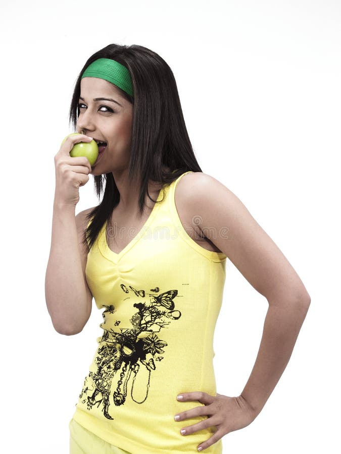 Asian girl eating a green apple