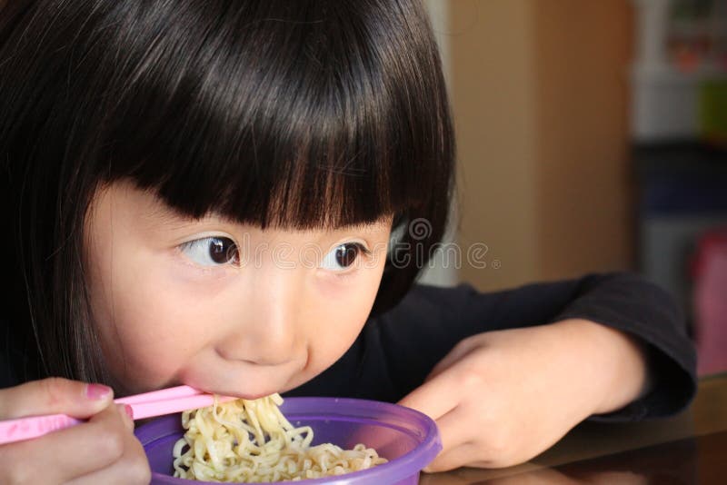 Asian girl eating noodles