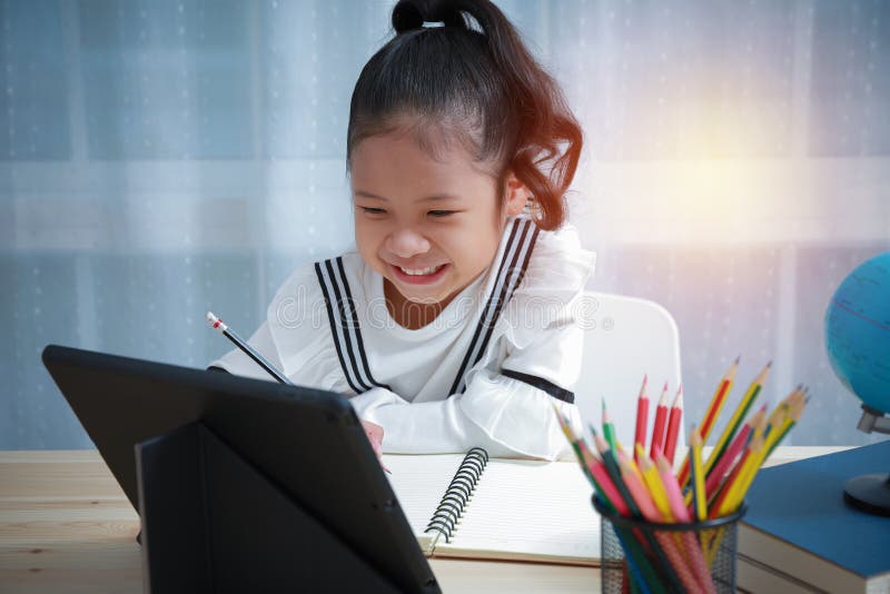 Asian Girl Is Happy Doing Homework Online At Home Stock Photo Image