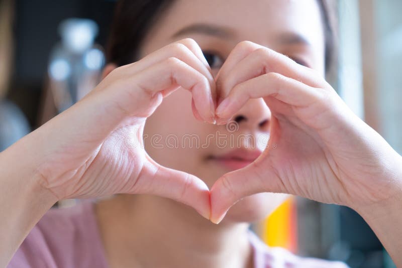 Asian girl and heart hand sing. Asian girl and heart hand sing