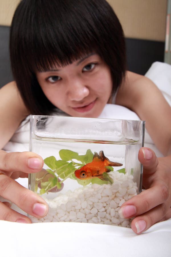 Asian girl with her goldfish
