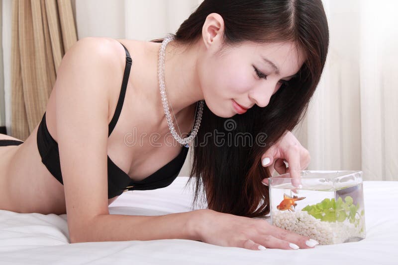 Asian girl with her goldfish