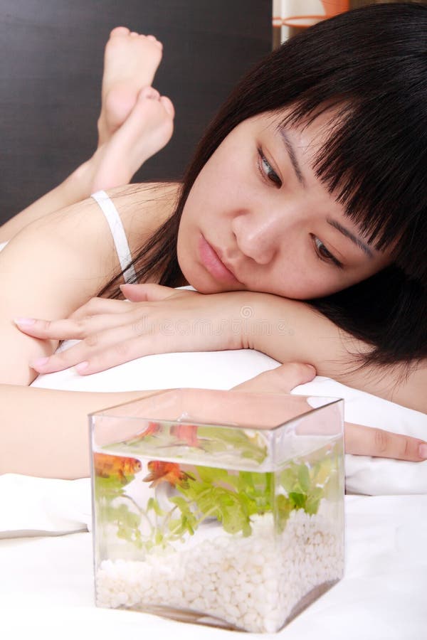 Asian girl with her goldfish