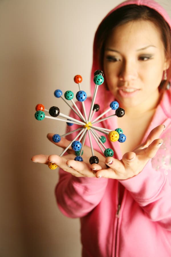 Asian girl holding 3-D diagram