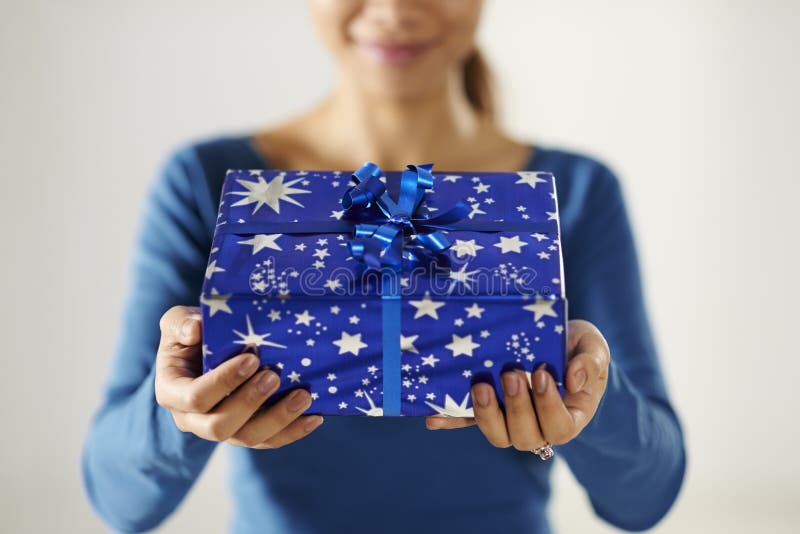 Asian girl holding gift box to the camera royalty free stock images Asian girl holding gift box to the camera royalty free stock images