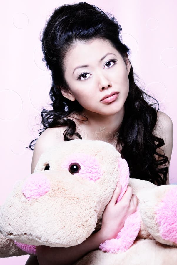 Asian girl holding stuff animal