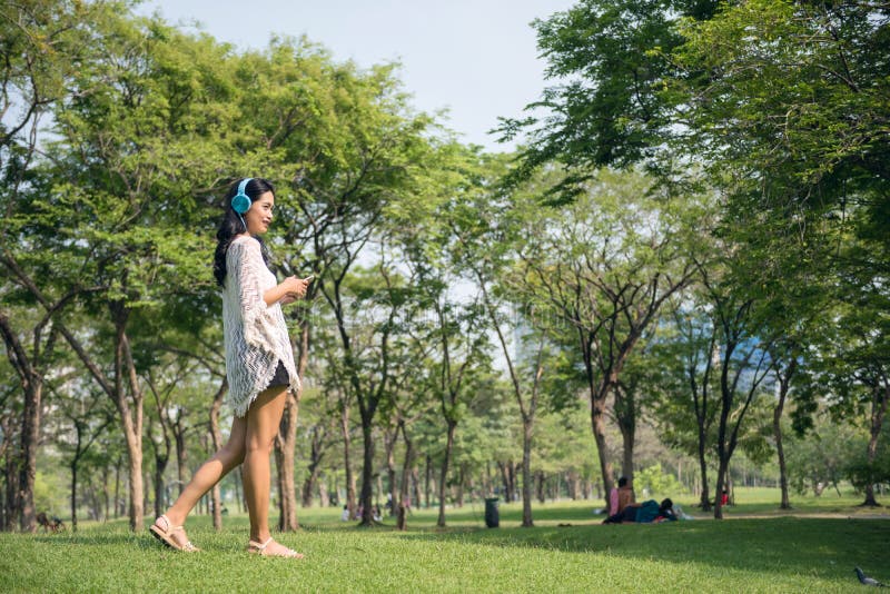 Asian girl listen music in park royalty free stock photos Asian girl listen music in park royalty free stock photos