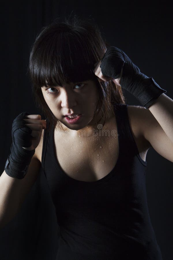 Asian girl Muay Thai fighter in defensive position