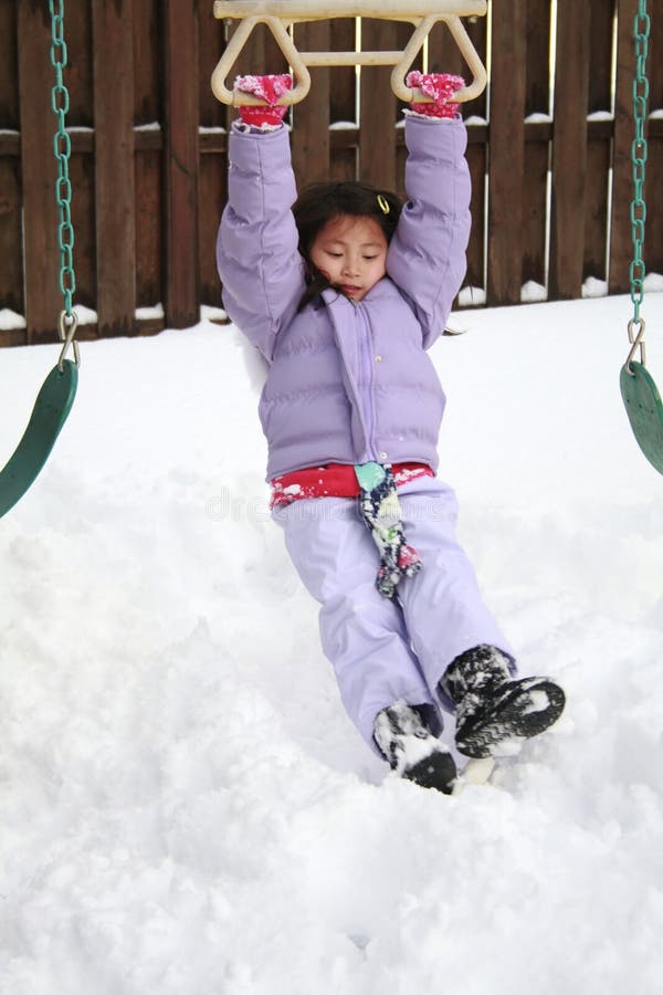 Asian girl playing in snow