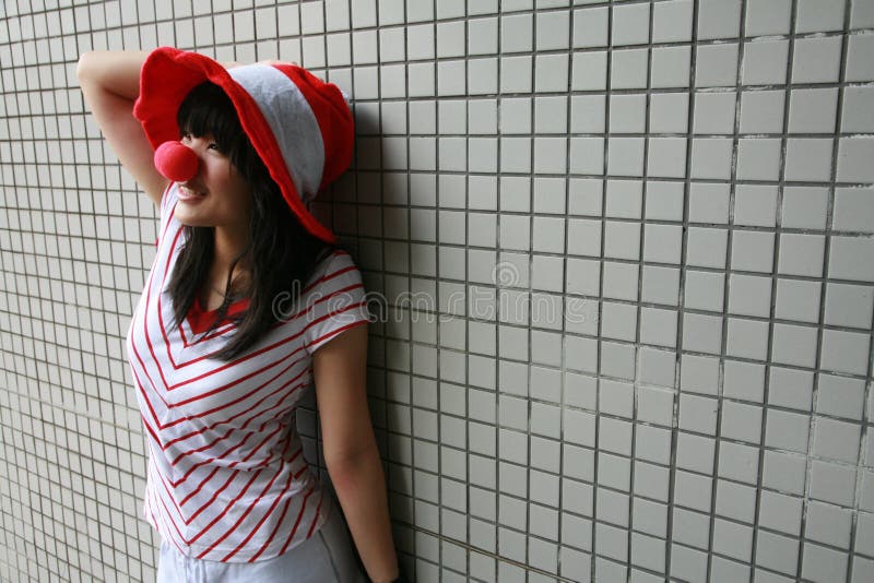 Asian girl with red nose and hat