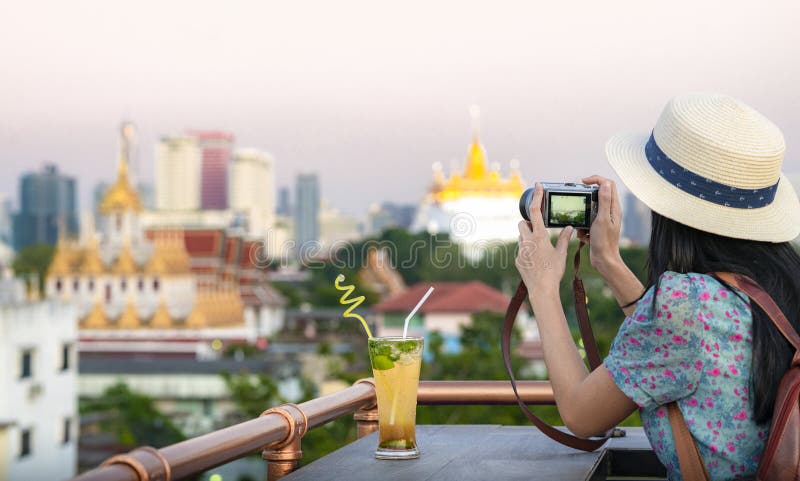 Asian girl relax on the roof top bar in Bangkok city and enjoy view point of loha prasat royalty free stock images Asian girl relax on the roof top bar in Bangkok city and enjoy view point of loha prasat royalty free stock images