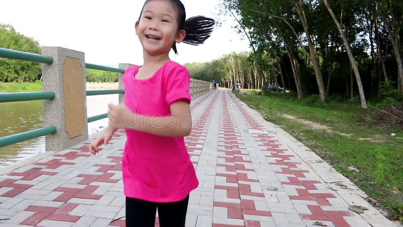 Asian girl runner wears her sport shoe to jogging. Healthy Lifestyle.
