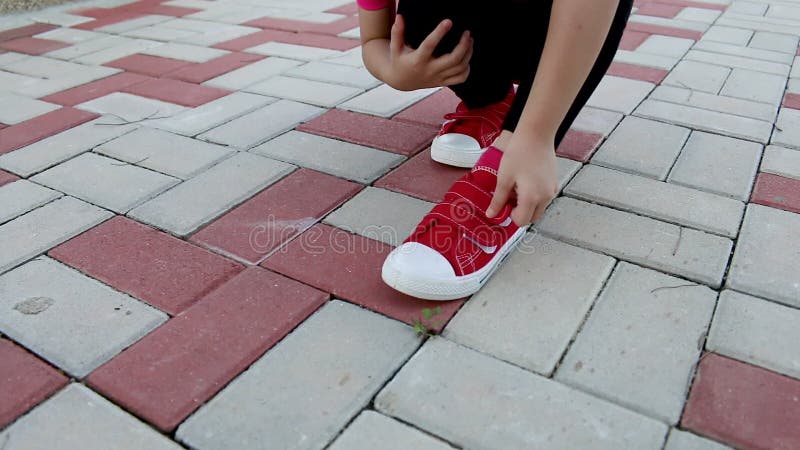 Asian girl runner wears her sport shoe to jogging. Healthy Lifestyle.