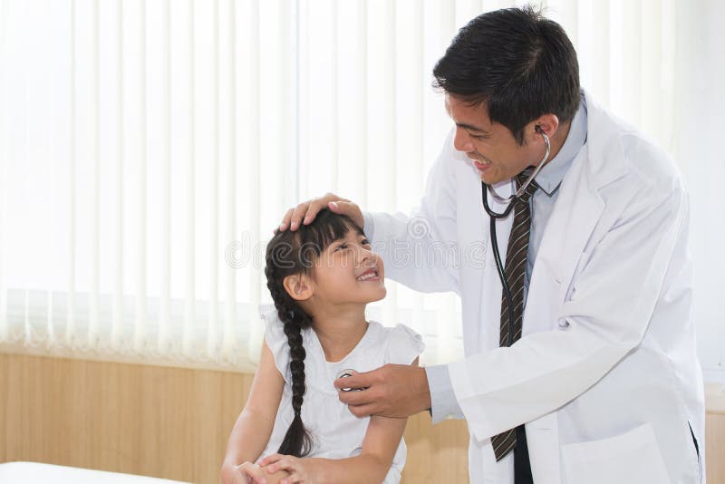 Asian Girl Was Happy While Doing A Physical Exam With The Doctor Stock