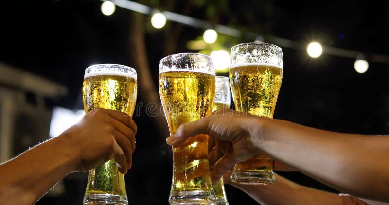 Asian group of friends having party with alcoholic beer drinks and Young people enjoying at a bar toasting cocktails and clinking