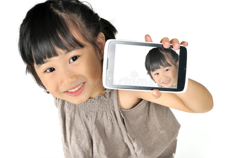 Asian happy little girl taking selfie by mobile phone isolated