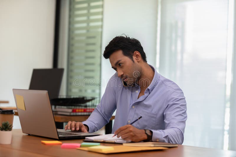 Asian indian business man talking with customer on mobile phone to get requirement and sale support