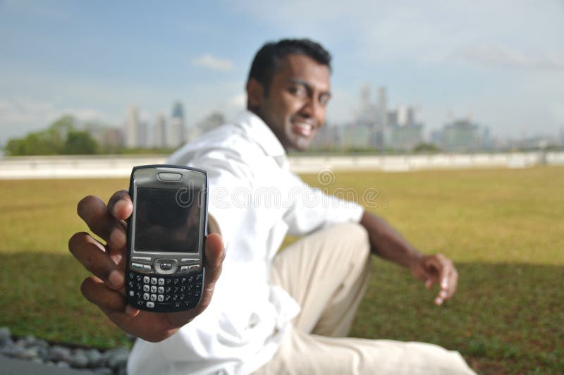 Asian Indian Male Showing his phone twittering