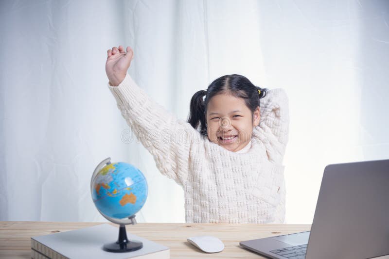 Very happy child playing game online with laptop stay at home. Asian boy  student online learning class study online video call teacher Stock Photo -  Alamy