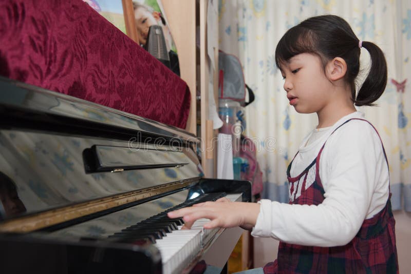 Asian kid playing piano stock photo. Image of home, childhood - 22788220