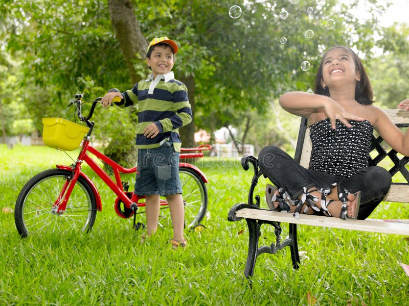 Asian kids playing in the park royalty free stock photo Asian kids playing in the park royalty free stock photo