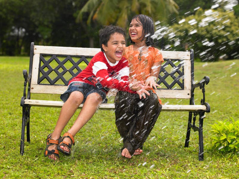 Asian kids playing in the rain stock images Asian kids playing in the rain stock images