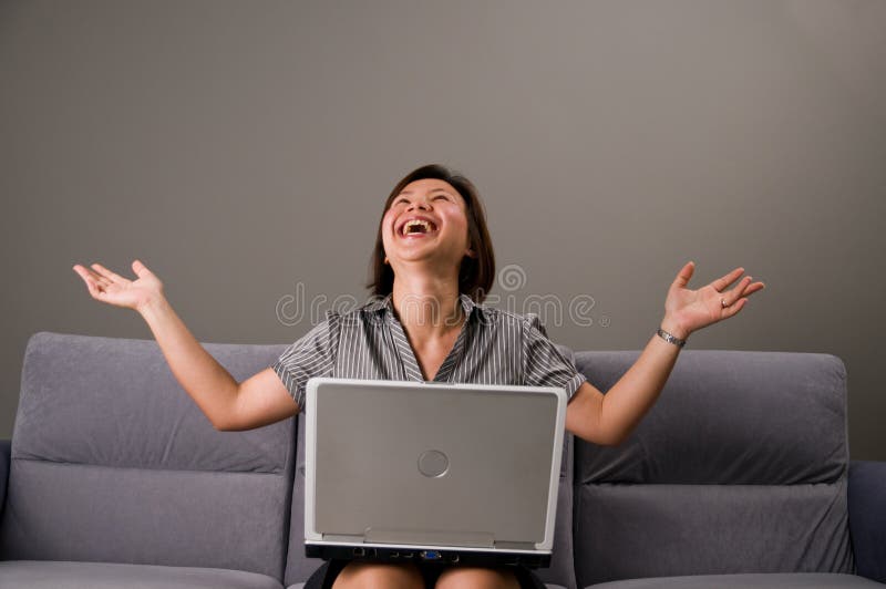 Asian lady in business attire, using a computer