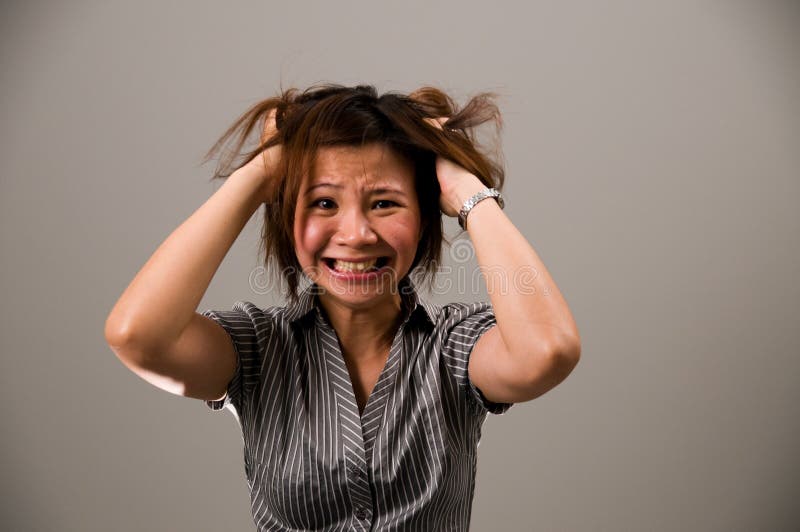 Asian lady in business attire, very frustrated