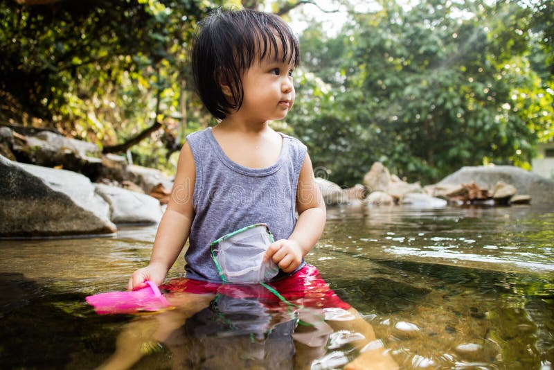 Asian Little Chinese Girl Playing in Creek