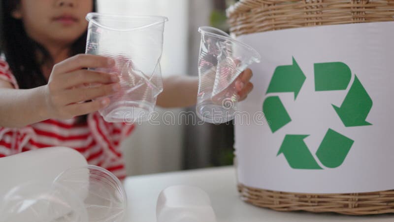 Asian little Girls dump plastic bottles in recycling boxes to reduce trash, reuse, and recycle. Recyclability and sustainability royalty free stock photography