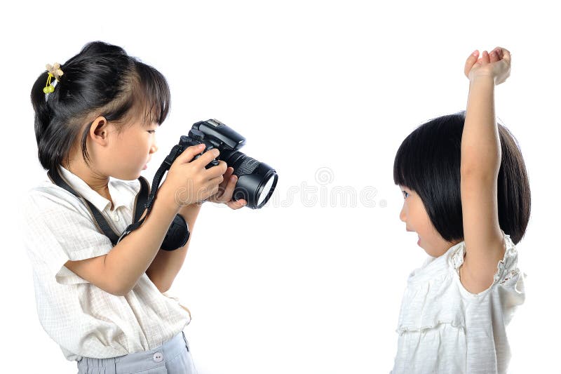 Asian little siblings child taking photograph of each other with