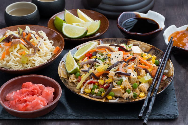 Asian Lunch Fried Rice with Tofu and Vegetables on Dark Table Stock