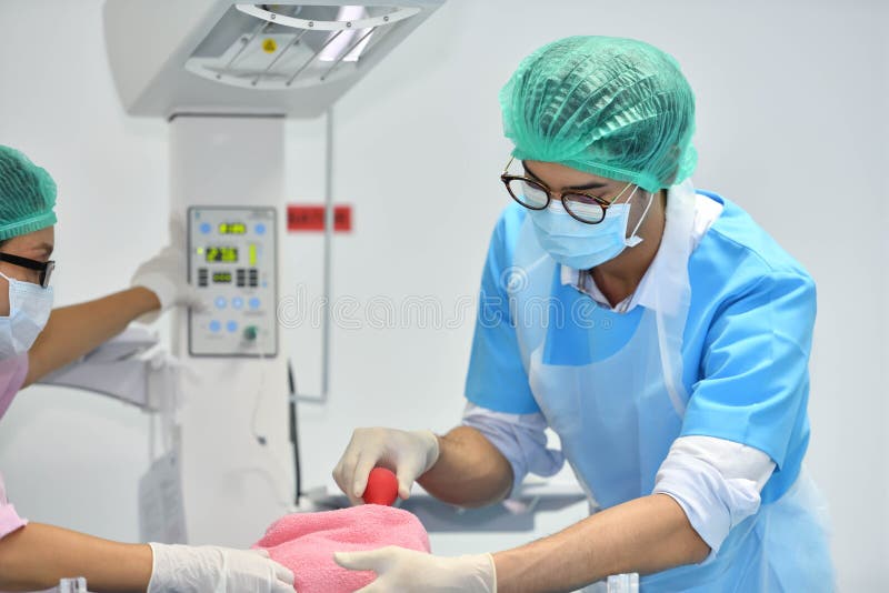 Asian male obstetrician and nurse are delivered to the patient stock photography Asian male obstetrician and nurse are delivered to the patient stock photography