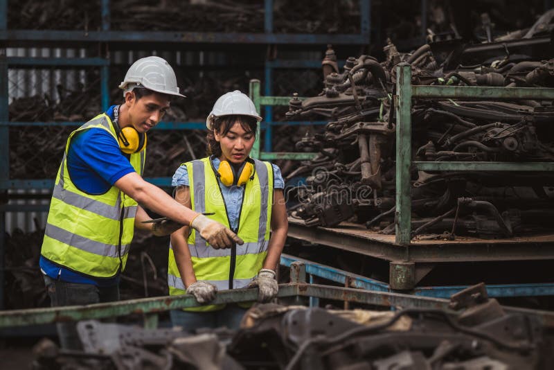 Asian male and woman worker happy working together in heavy industry factory royalty free stock photos