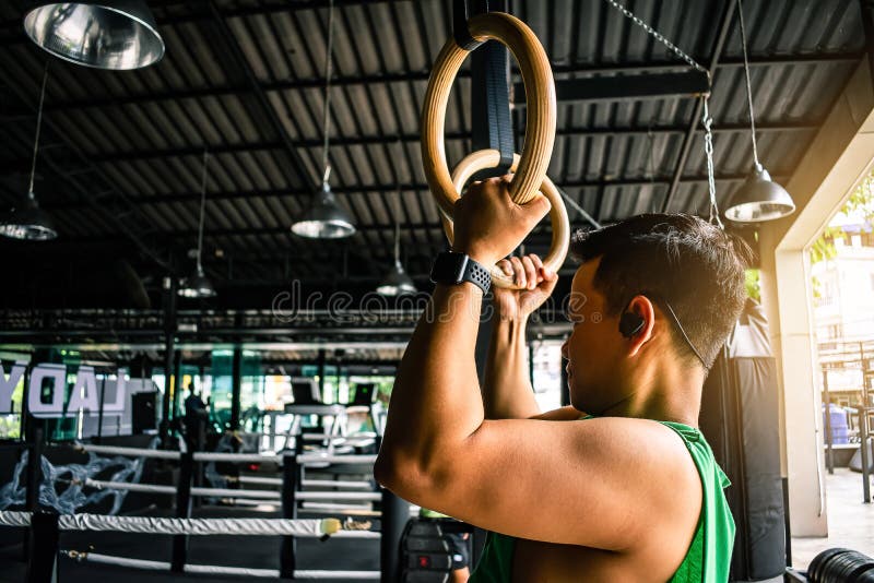 Asian man athlete gymnast rings exercise in gymnastics exercise stock photo Asian man athlete gymnast rings exercise in gymnastics exercise stock photo