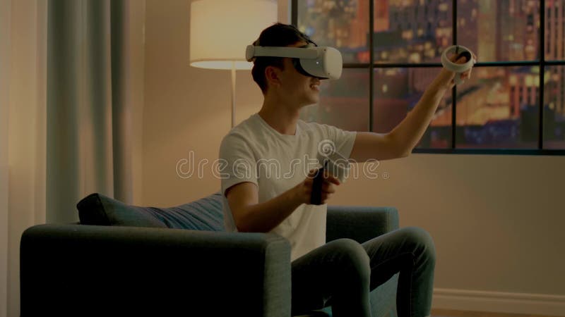 Asian man developer in virtual reality headset moves hands