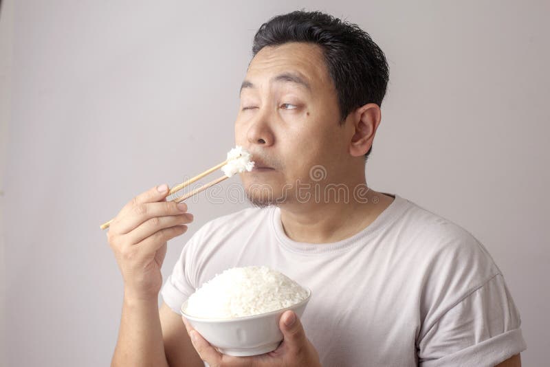 Asian Man Eating Rice stock image. Image of ingredient - 148279375