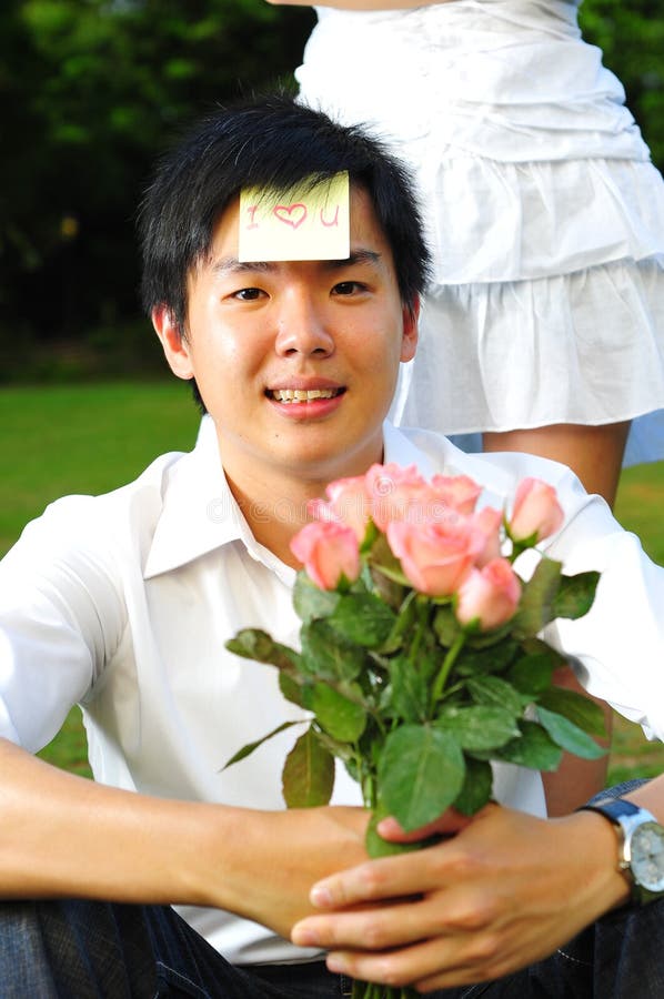 Asian Man holding Pink Roses