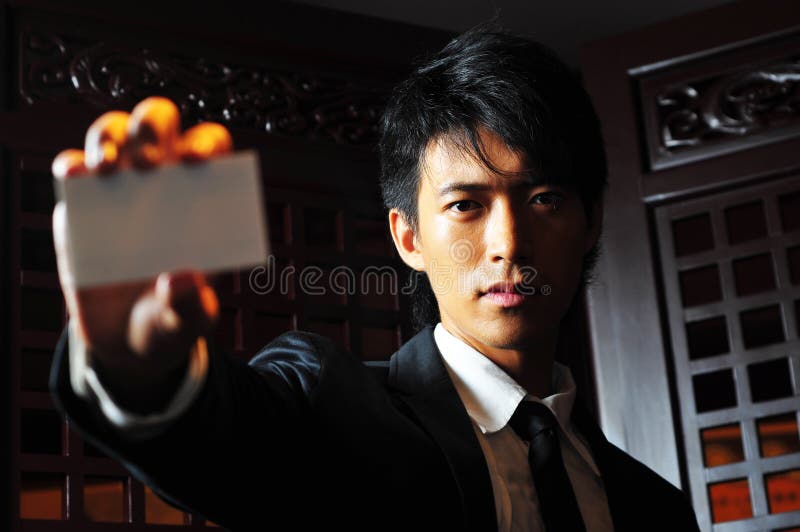 Asian Man Holds Business Card