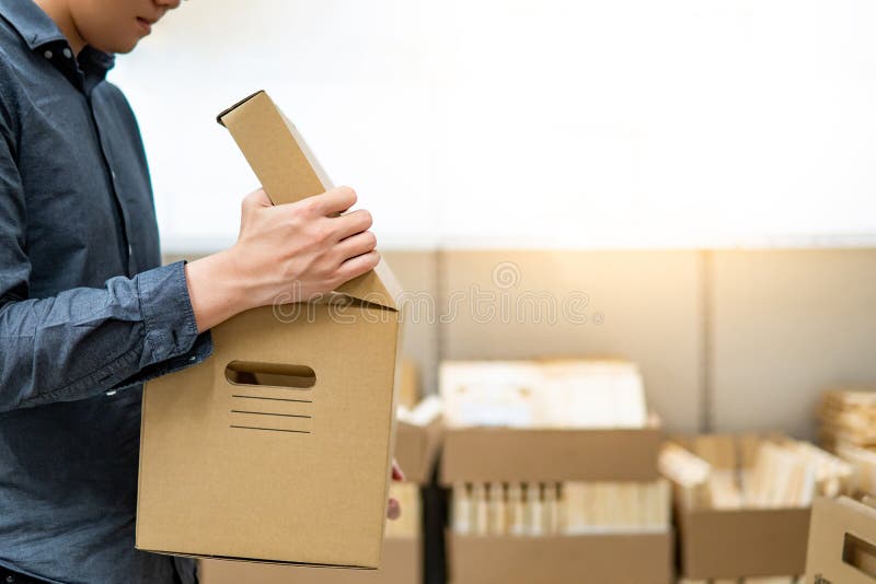 Asian man opening cardboard box lid stock photos Asian man opening cardboard box lid stock photos