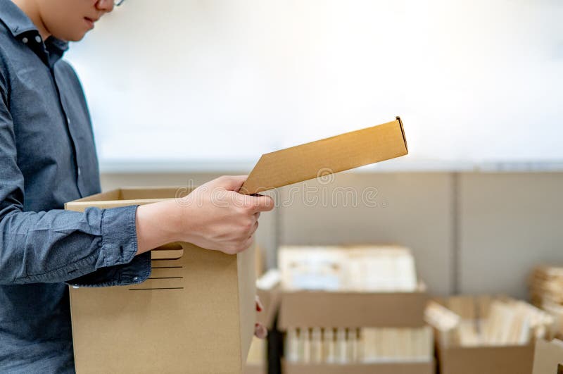 Asian man opening cardboard box lid stock photography Asian man opening cardboard box lid stock photography