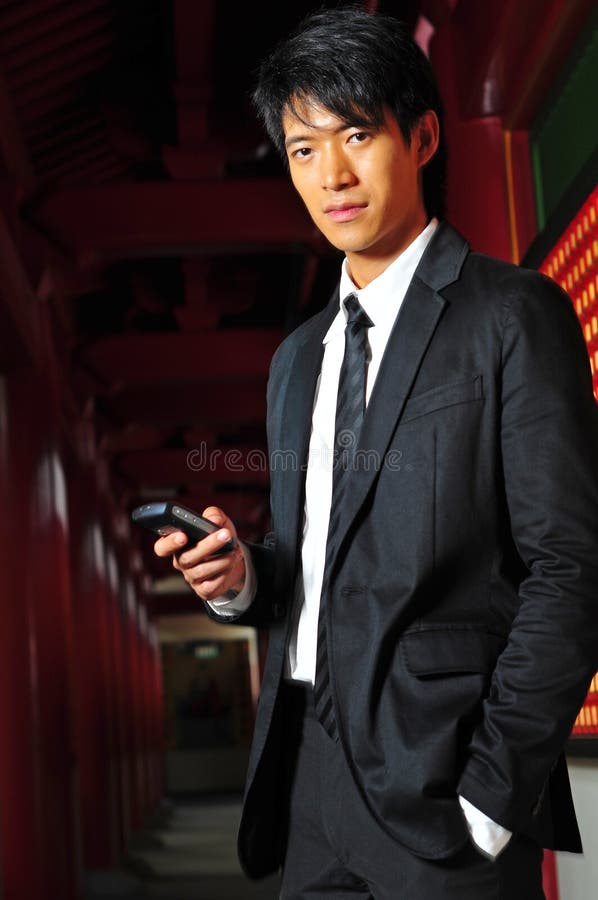 Asian Man In Suit with Phone