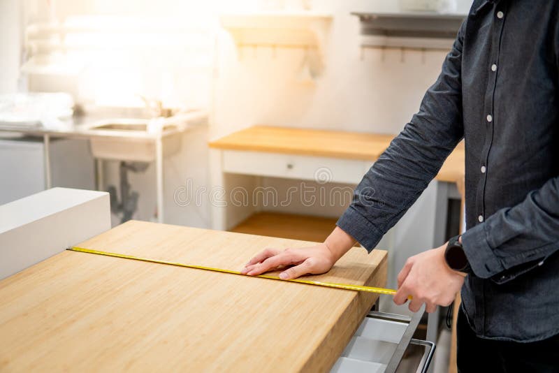 Asian Man Using Tape Measure On Countertop Stock Image Image Of