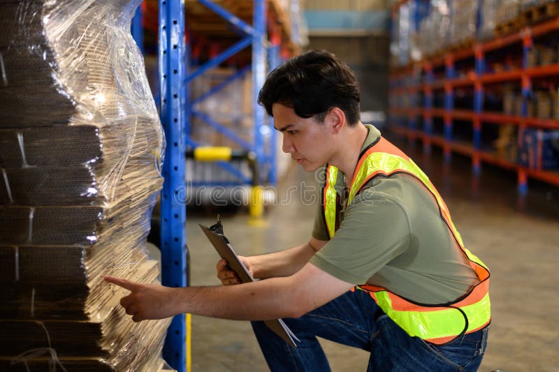 Asian man warehouse managers checking stock in workplace warehouse. industry logistic export import distribution concept royalty free stock photo