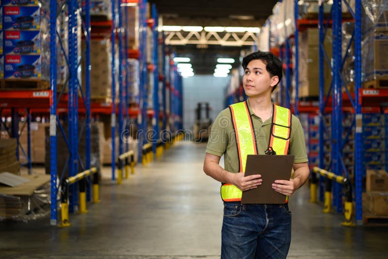 Asian man warehouse managers checking stock in workplace warehouse. industry logistic export import distribution concept stock photo