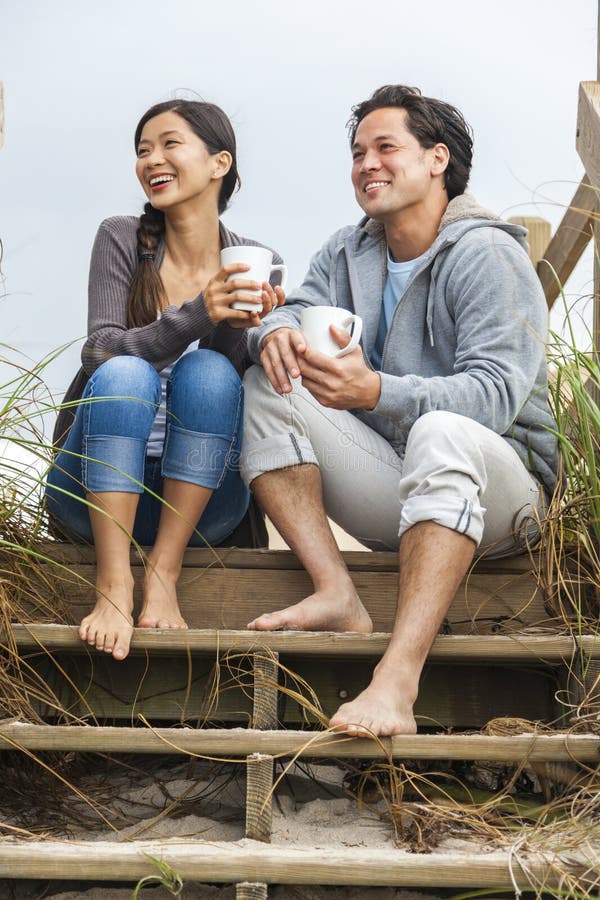 Asian Man Woman Couple Drinking Coffee Beach Steps stock photos Asian Man Woman Couple Drinking Coffee Beach Steps stock photos