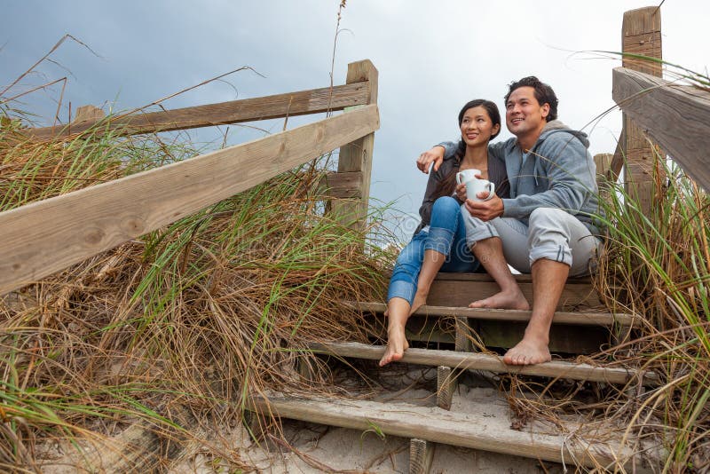 Asian Man Woman Romantic Couple on Beach Steps royalty free stock image Asian Man Woman Romantic Couple on Beach Steps royalty free stock image