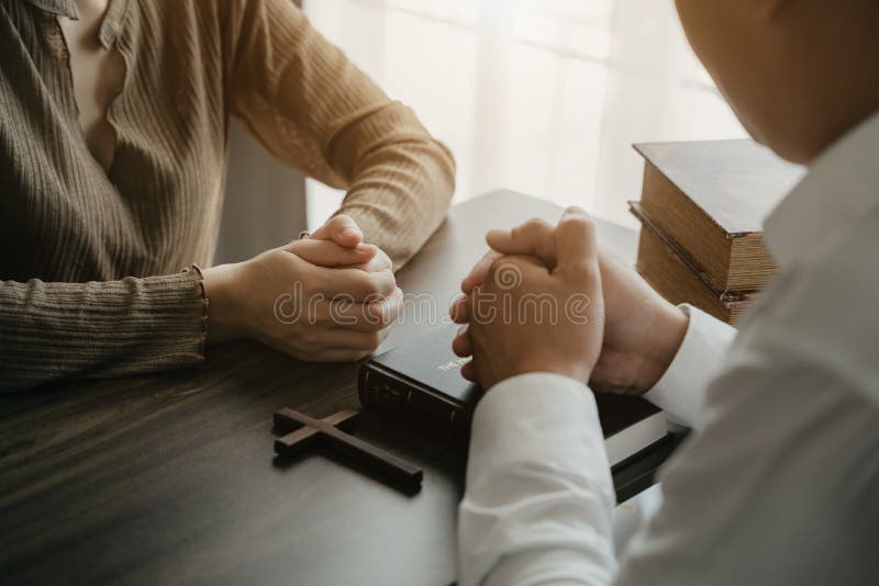 Asian men and women hands praying to god with the bible. Pray for god blessing. Religious beliefs Christian life crisis prayer to