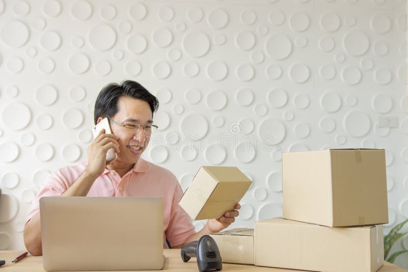 Asian Middle-aged man using Smartphone with laptop for work at h royalty free stock photos Asian Middle-aged man using Smartphone with laptop for work at h royalty free stock photos