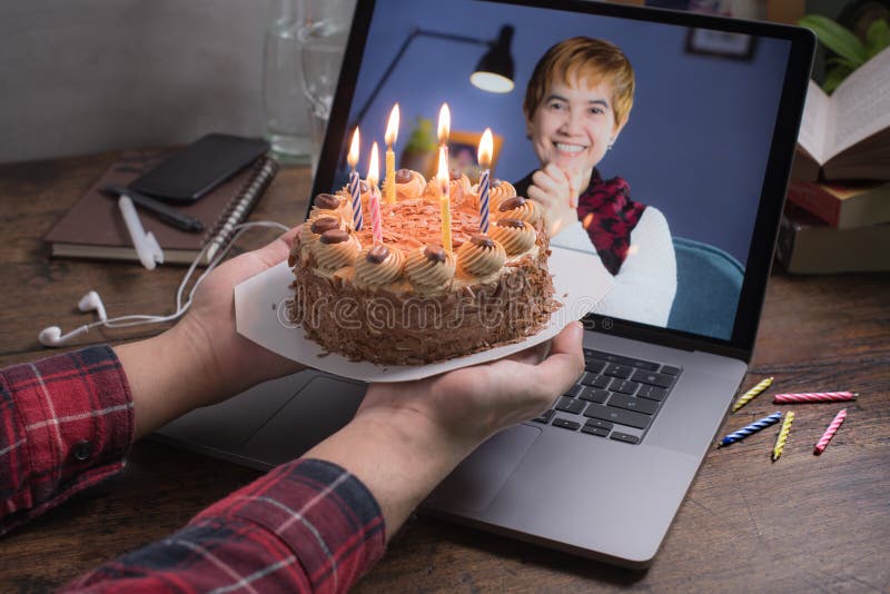 Asian Middle Aged Woman Feeling Loved and Happy while Celebrating Virtual Birthday Via Video Call at Home Stock Photo
